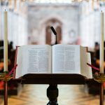 selective focus photography opened Bible on book stand