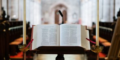 selective focus photography opened Bible on book stand